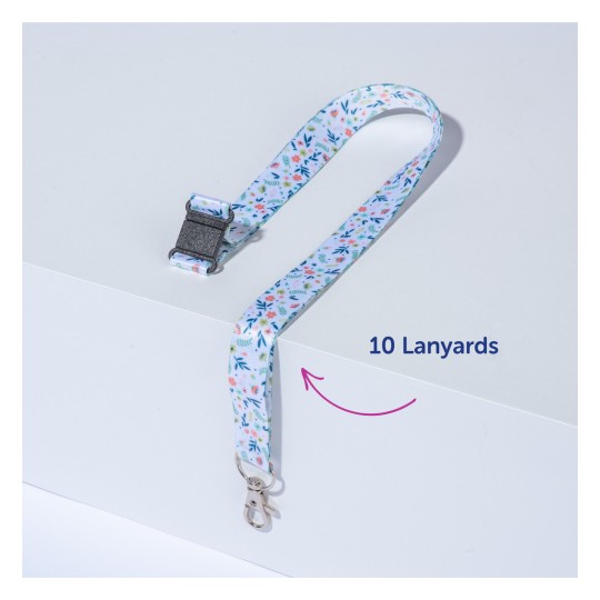 Bilden visar ett färgglatt nyckelband med en blommig design och ett spänne. Det ligger på en plan yta, med en etikett som anger "10 nyckelband".
