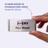 Bilden visar en hand som håller en namnbricka i rostfritt stål. Brickan har namnet 'Paul Meyer' och logotypen för 'Avery'. Den anger att produkten innehåller 10 namnskyltar med måtten 70 x 30 mm.